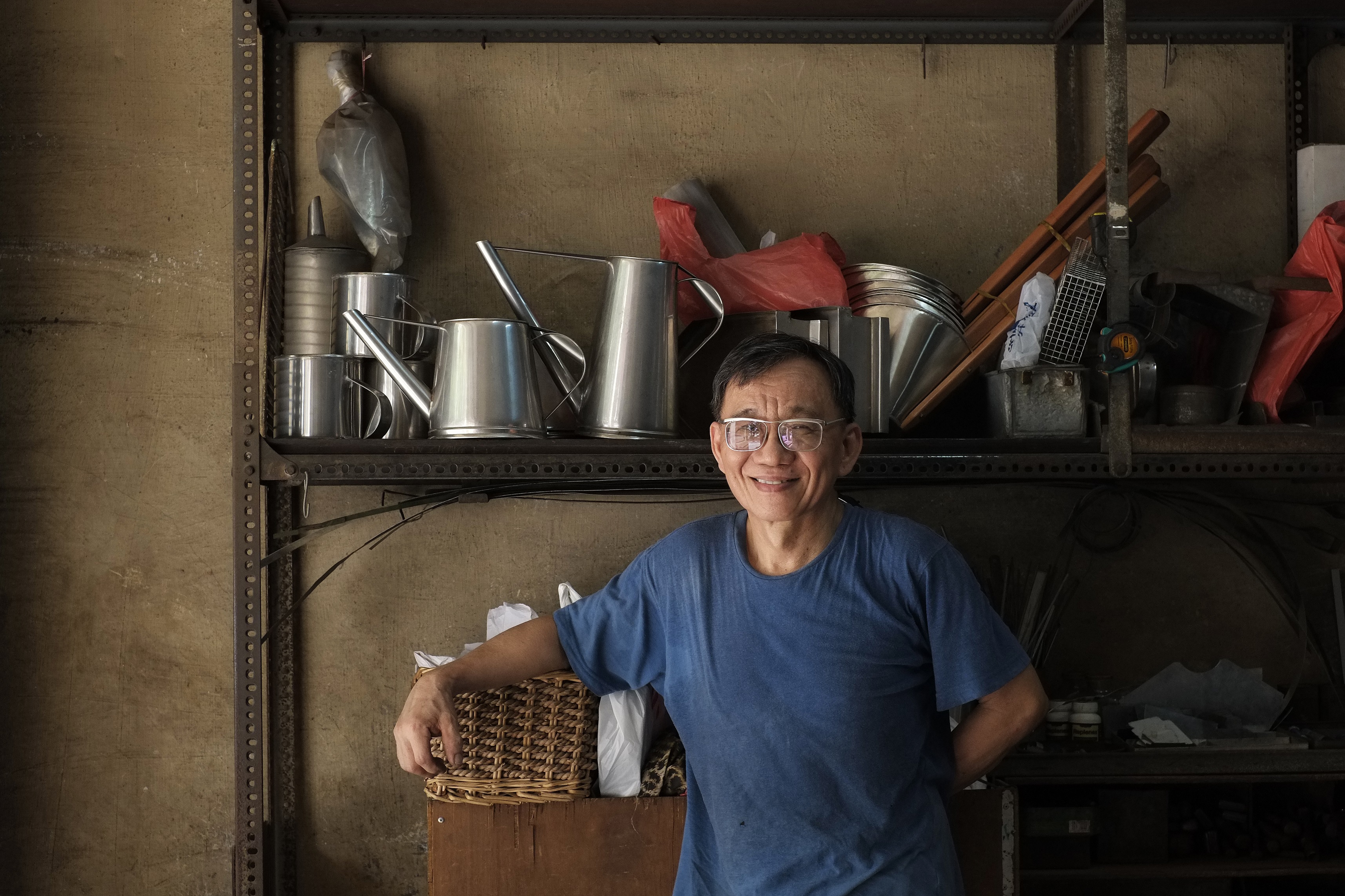 STANDING PROUD: Jimmy poses at ease with various metal kopi tins and tools                     