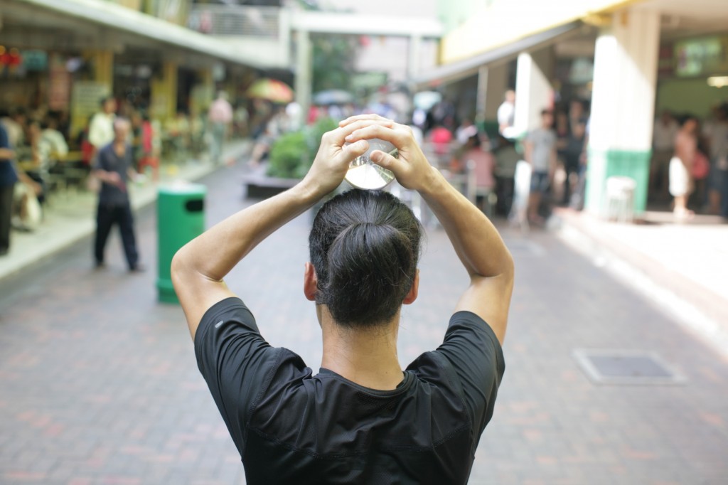 WARM UP: Daisuke Onoe, who goes by the performance name of Jonasun, warms up in front of a small but slowly growing curious crowd in Chinatown.