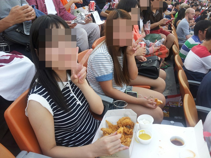 North Korean defectors with PSCORE at a baseball game. Faces have been blurred to protect their identity.