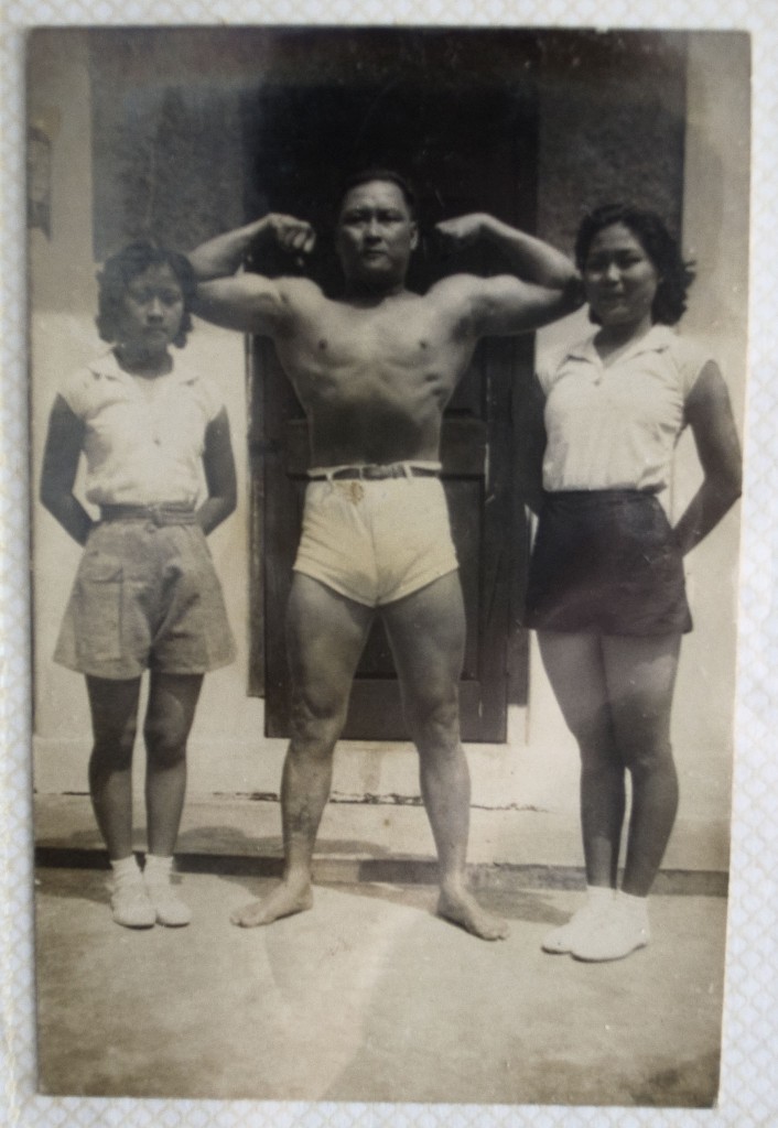 Father Ho strikes a pose as his daughters stand beside him. Tai Ma is on the right.