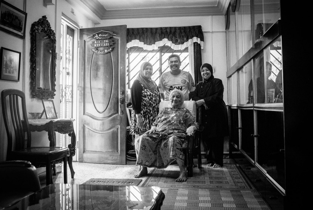 Pulau Seking Penghulu’s wife Saniah Bte Ali with her children Rahimah and Kamal, and his wife. Since their resettlement from the island in 1994, they’ve called this West Coast flat their home. 