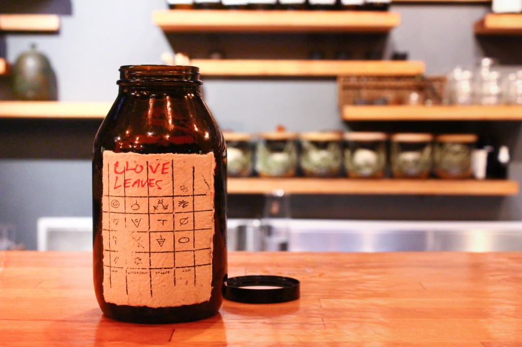 A bottle of foraged clove leaves Vijay dehydrated and keeps behind the bar