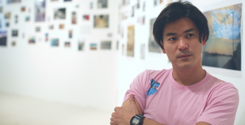 SCOPING US OUT: Photographer ND Chow speaking to Contented at his gallery exhibition.