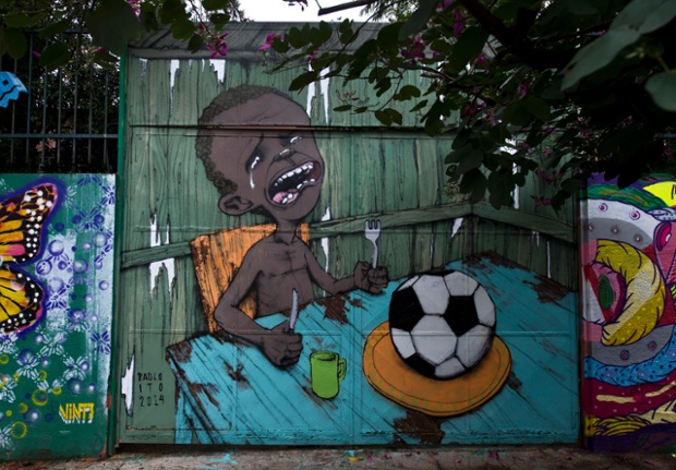 FOOD, NOT FOOTBALL: A graffiti painted by Brazilian street artist Paulo Ito on the entrance of a public schoolhouse in Sao Paulo, Brazil. The picture of the graffiti depicting a starving child with nothing to eat but a football has been shared more than 50,000 times on Facebook. 